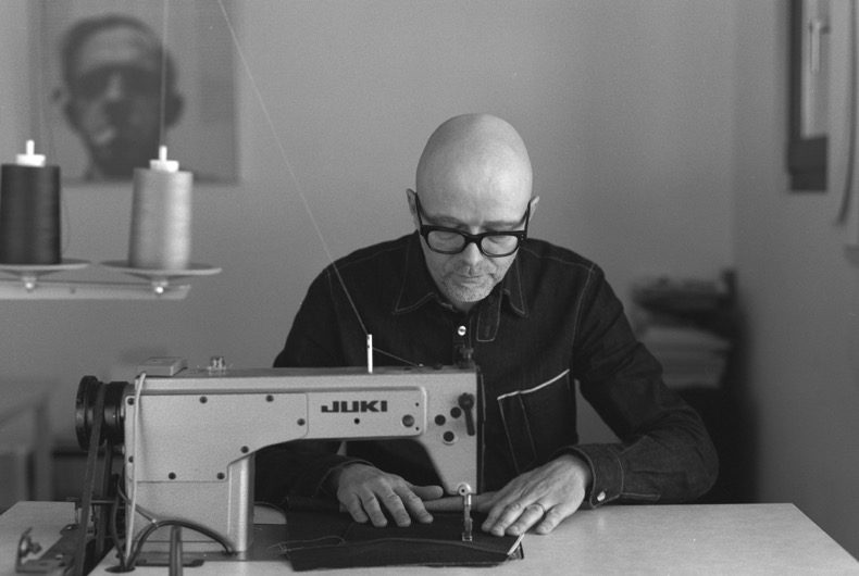 Paul Kruize sitting and sewing